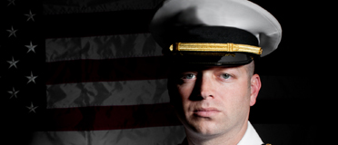 Navy Sailor in front of US Flag