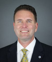 Photo of Man with brown hair, blue eyes and gold tie