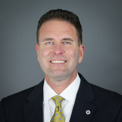 Photo of Man with brown hair, blue eyes and gold tie