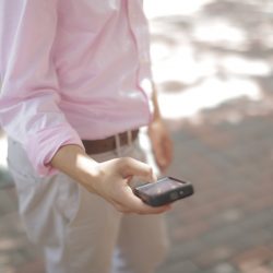 guy-in-pink-shirt-looking-at-phone